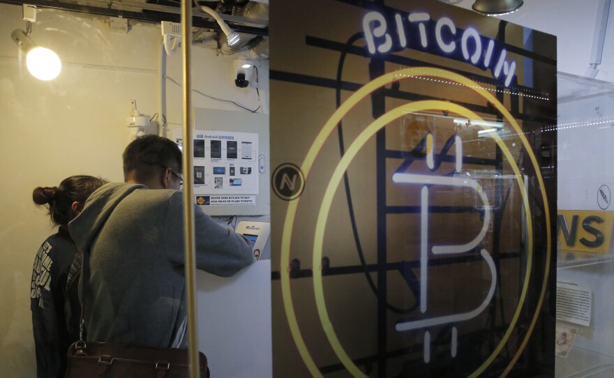 People use the bitcoin ATM in Hong Kong, on Friday.