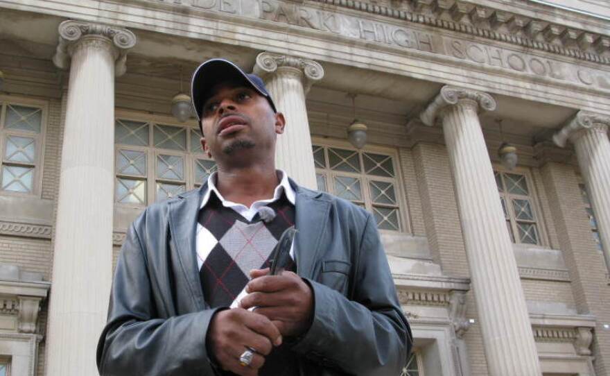 Herman Rainey, the Safe Passage coordinator for Leave No Veteran Behind, waits outside Chicago's Hyde Park Academy High School just before dismissal time.