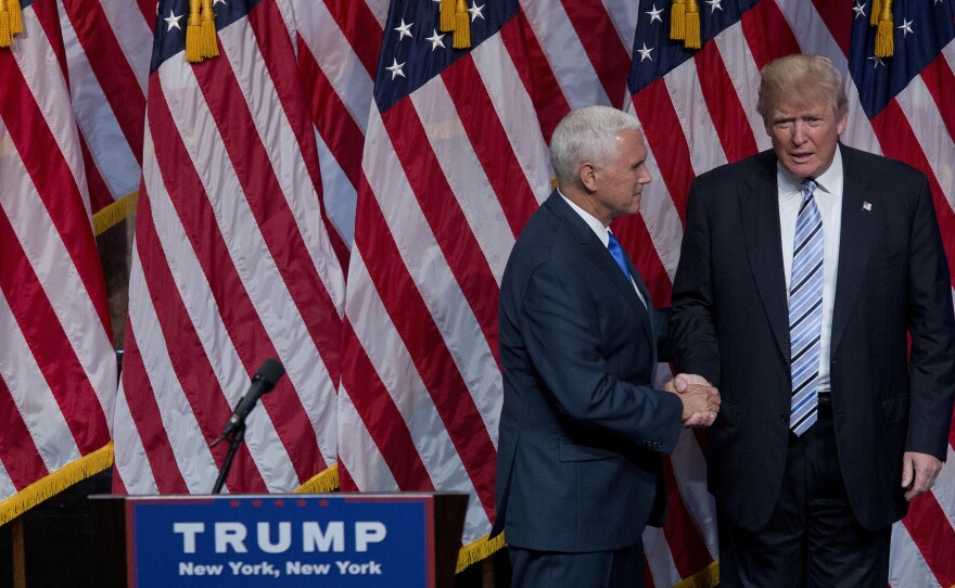Donald Trump shakes hands with the man he picked to be his running mate, Gov. Mike Pence of Indiana, on Saturday in New York.