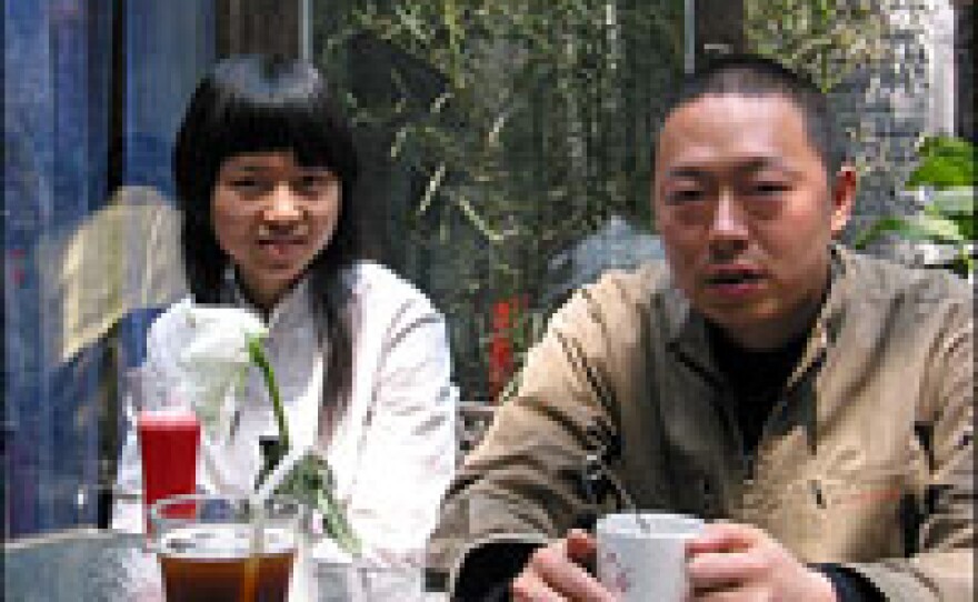 Artist and former police officer Wu Youming (right) and his wife, Zhou Li, at a café in Beijing's 798 arts district.