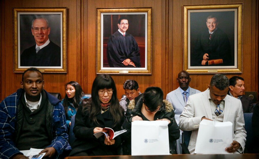 In 2017, hundreds of thousands of immigrants are expected to be naturalized as U.S. citizens in ceremonies around the country, much like this one in Kansas City, Mo.