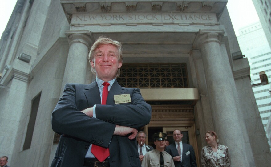 Donald Trump poses for photos outside the New York Stock Exchange in June 1995.