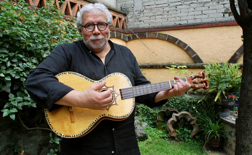Guillermo Contreras strums the five-string <em>guitarra de golpe</em>.