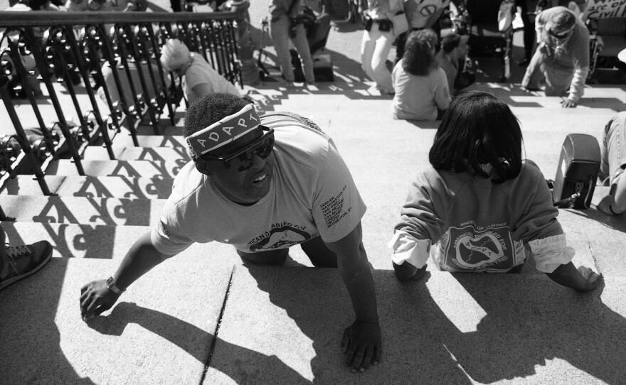 ADAPT activists drag themselves up the Capitol steps at the "Capitol Crawl" demonstration in Washington, D.C. on March 12, 1990.