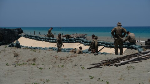 Soldiers of the U.S. Army's 25th Infantry Division build fighting positions along the beach of the La Paz sand dunes in Laoag City, Philippines, ahead of counterlanding exercises during annual Balikatan drills.