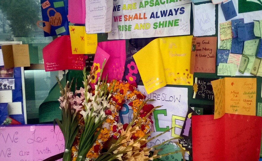 Noticeboards are festooned with pictures, cards and bouquets of flowers at the Army Public School in Peshawar.