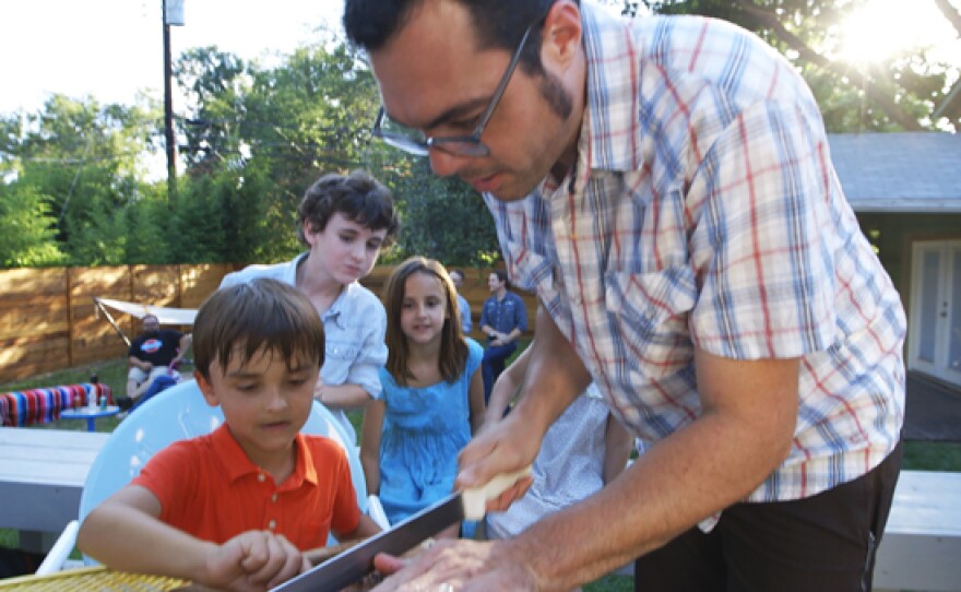 Aaron Franklin, widely regarded as one of the most influential pitmasters in the United States, slicing BBQ for kids.