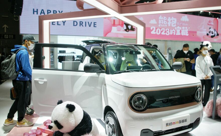 Visitors look at a Geely Panda Mini on the opening day of the 20th Guangzhou International Automobile Exhibition in Guangzhou, in China's southern Guangdong province on Dec. 30, 2022.