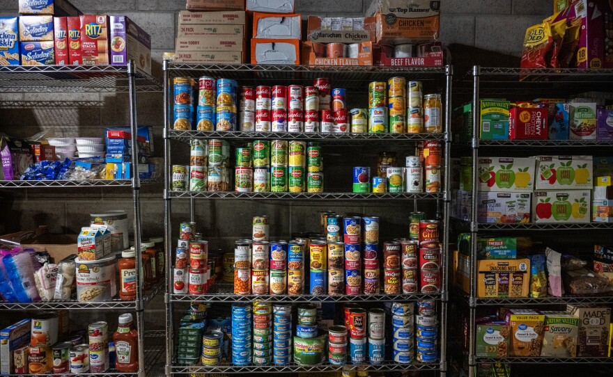 Supplies are stacked in shelves in a garage space at the property where dozens of displaced residents from Lahaina are staying.