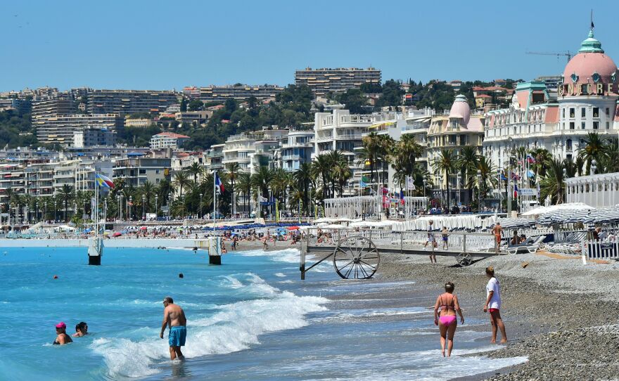 People visit the beach on July 16 in Nice. The Bastille Day attack took place on the adjacent Promenade des Anglais.