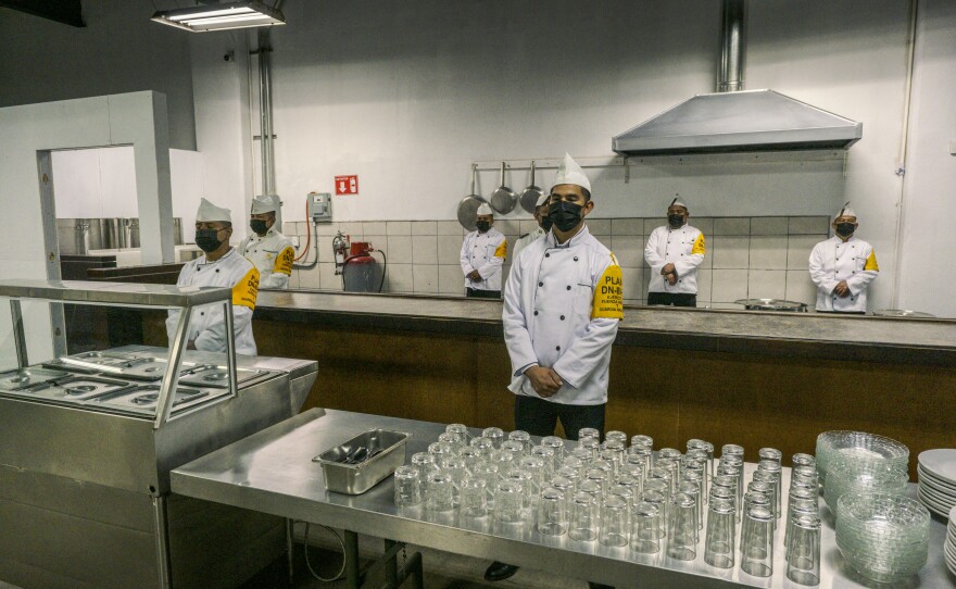 Workers stand ready in the kitchen at a new shelter for deportees in Tijuana, Mexico. Jan. 25, 2025