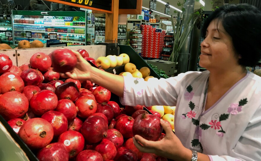 Rebeca Gonzalez says she can now afford to buy pomegranates for her family in Garden Grove, Calif., because of the extra money she receives through Más Fresco, a food stamp incentive program for purchasing produce.