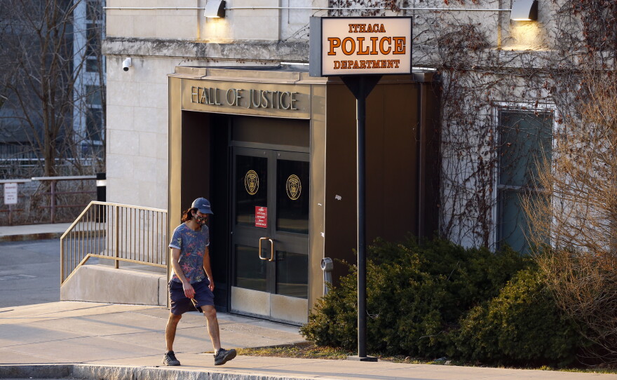 A person walks by the Ithaca Police Department headquarters on March 22, 2021, in Ithaca, N.Y.