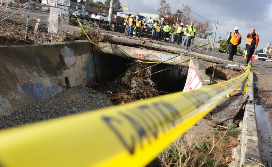 Workers from the city of San Diego and San Diego Metropolitan Transit System survey damage in a storm drain that parallels Imperial Avenue in San Diego's Encanto neighborhood, Jan. 23, 2024.