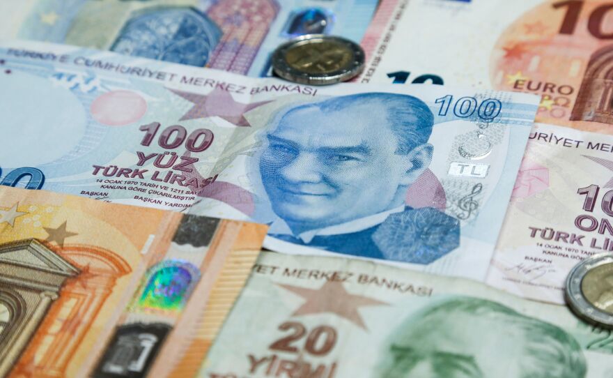 A pile of Turkish lira and euro banknotes sit atop a table earlier this month. The currencies of Turkey and other emerging economies have been falling against the U.S. dollar, which has been boosted by rising interest rates.