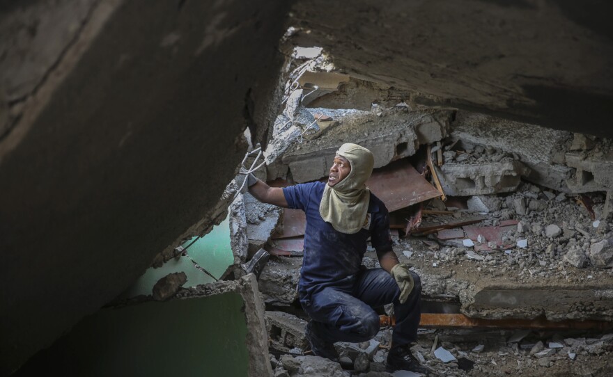 <strong>Sun., Aug. 15:</strong> A firefighter searches for survivors inside a damaged building, after Saturday´s 7.2 magnitude earthquake in Les Cayes.
