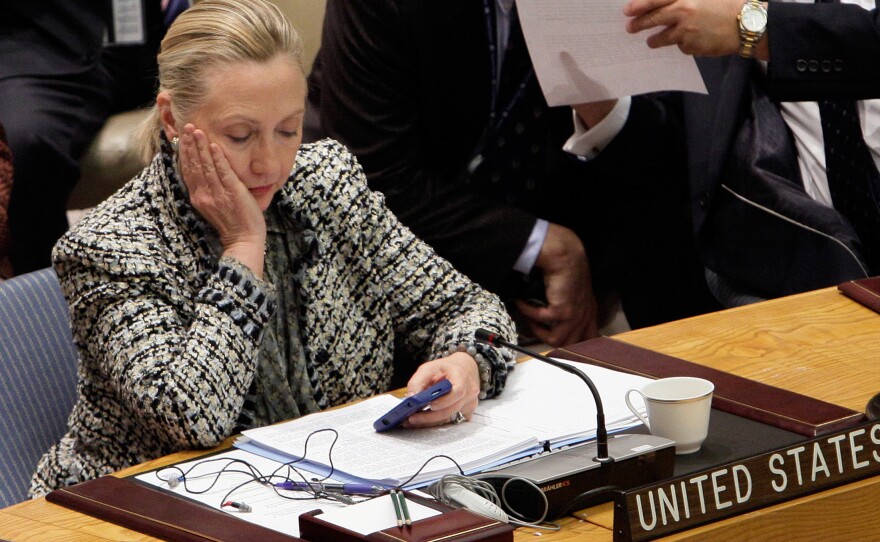 Hillary Clinton, then secretary of state, checks her cellphone after her address at a United Nations meeting in 2012.