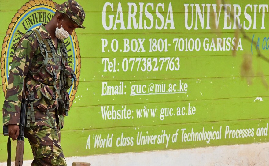 A Kenya soldier walks past the front entrance of Garissa University Friday. Kenya's interior minister vowed that the country would not bow to terrorist threats, a day after the massacre of 147 students.