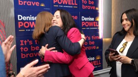 Denise Powell, candidate for the Democratic nomination to the House of Representatives in Nebraska's second district, right, hugs pollster Madeline Conway during an election night watch party Wednesday in Omaha, Neb.