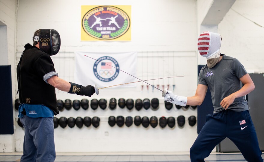 Alex Massialas (right), the reigning individual silver medalist from the 2016 Olympic Games, practices with his father Greg Massialas at the Massialas Foundation fencing studio in San Francisco on July 14, 2021. Alexander Massialas is a right-handed foil fencer and will be heading to his third Olympic games in Tokyo this year along with Greg Massialas, who will serve as the men’s foil team coach.
