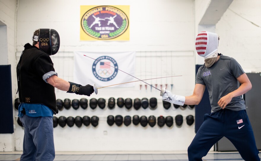 Alex Massialas (right), the reigning individual silver medalist from the 2016 Olympic Games, practices with his father Greg Massialas at the Massialas  Foundation fencing studio in San Francisco on July 14, 2021. Alexander Massialas is a right-handed foil fencer and will be heading to his third Olympic games in Tokyo this year along with Greg Massialas, who will serve as the men’s foil team coach.