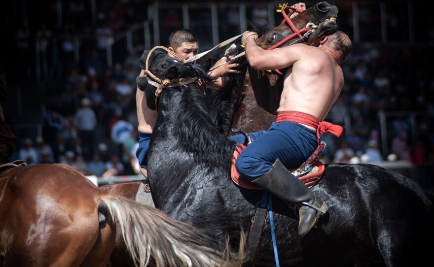Two competitors engage in er-enish — wrestling on horseback.