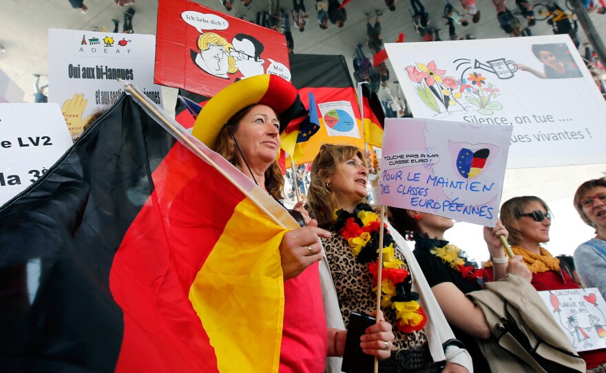 Striking French teachers hold a German flag as they take part in a nationwide protest against new measures aimed at revamping the country's school system, in Marseille, France, on May 19. France's 840,000 teachers are largely opposed to the reform, their unions say, fearing it will increase competition between schools and exacerbate inequalities.