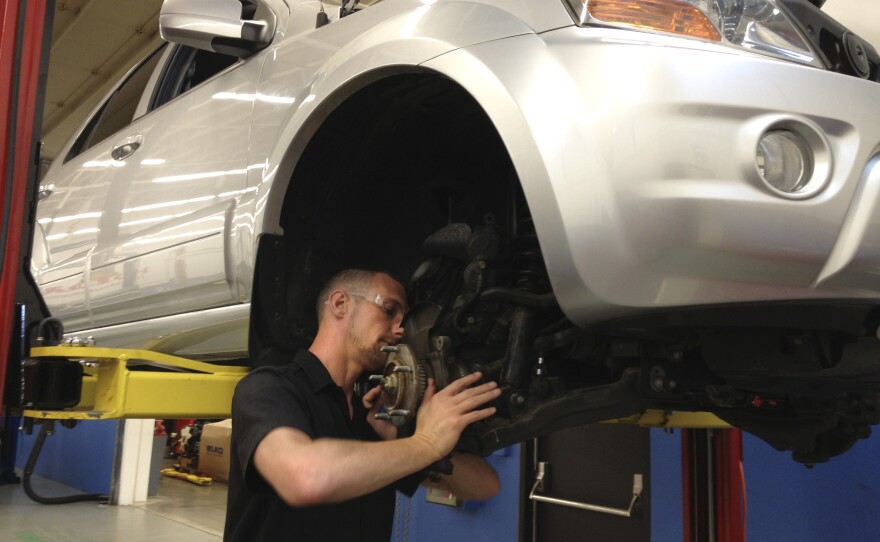 C.J. Forza, a student in the I-BEST program in Washington state, repairs a car for class at Shoreline Community College.