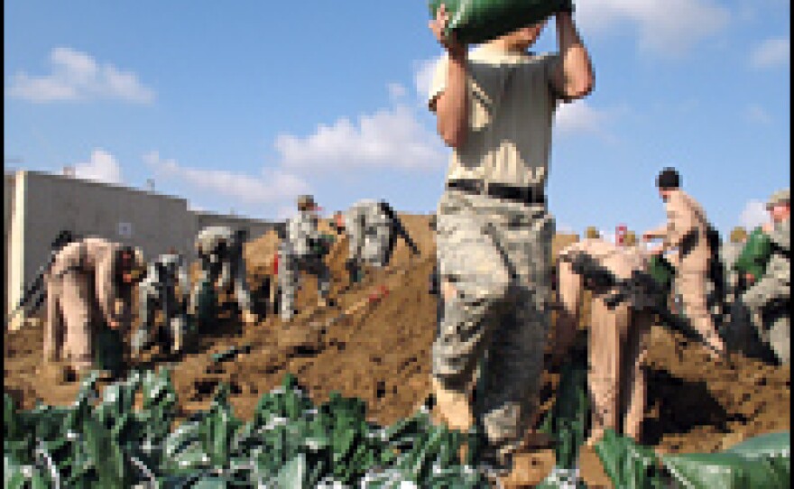 American soldiers fill sand bags at Camp Ramadi Jan. 9, 2007, in Ramadi, Iraq.
