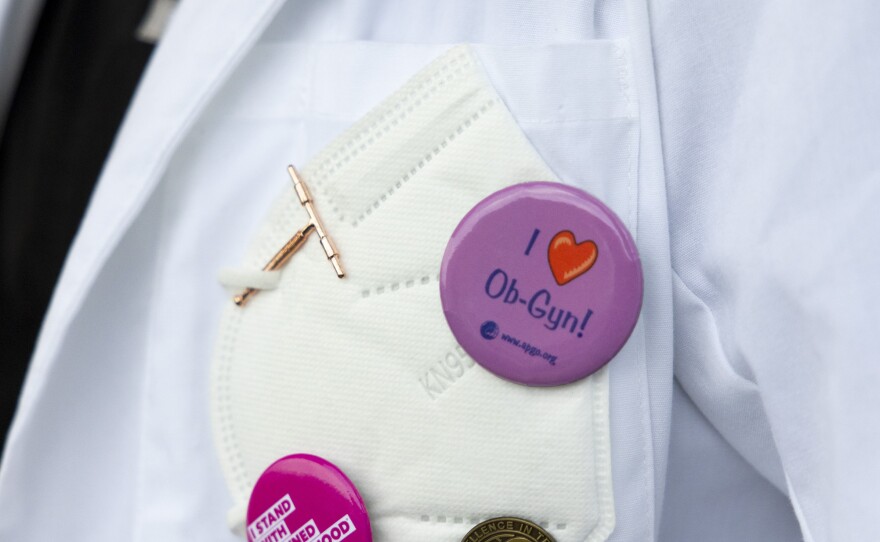 Pins on Dr. Neelima Sukhavasi's coat pocket show her support for women's reproductive health, Baton Rouge, La., on Monday, March 18, 2024.