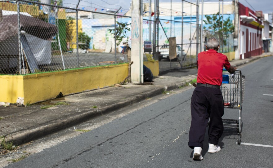 A man outside the site of a community kitchen — or <em>comedor social</em> — in the city of Caguas. The community kitchens became an important source of food after Hurricane Maria, when the local and federal governments failed to get supplies to people frantic for them. During the pandemic, the <em>comedores </em>have been providing free groceries.