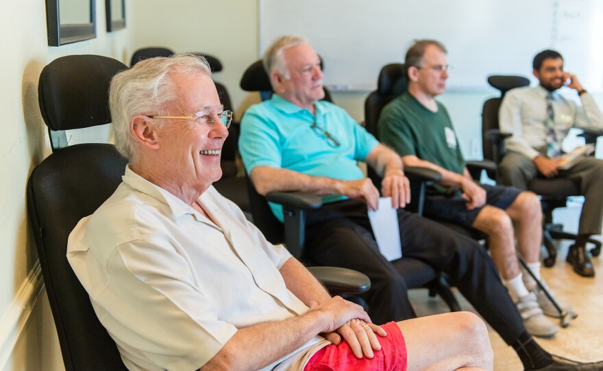 John Evard (left) participated in group therapy during his stay at the rehab center. He was prescribed increasing dosages of opioids to manage his pain, Evard says, but it didn't work, and he was unable to quit the pills on his own. "I was effectively housebound," he says.