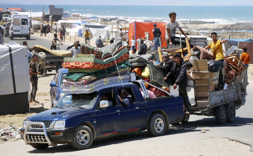 Hundreds of Palestinians leave eastern Rafah for the coastline of Deir al-Balah after the Israeli army announced it has taken control of the Palestinian side of the Rafah border crossing, in the Gaza Strip, Tuesday.