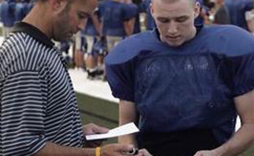 Newcastle H.S. athletic trainer Damon Glass administering King Devick test.