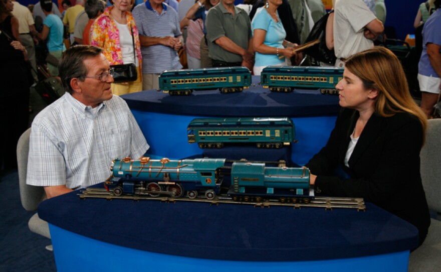 Leila Dunbar (right) appraises a Lionel Blue Comet train, ca. 1935 in Baltimore, Maryland.