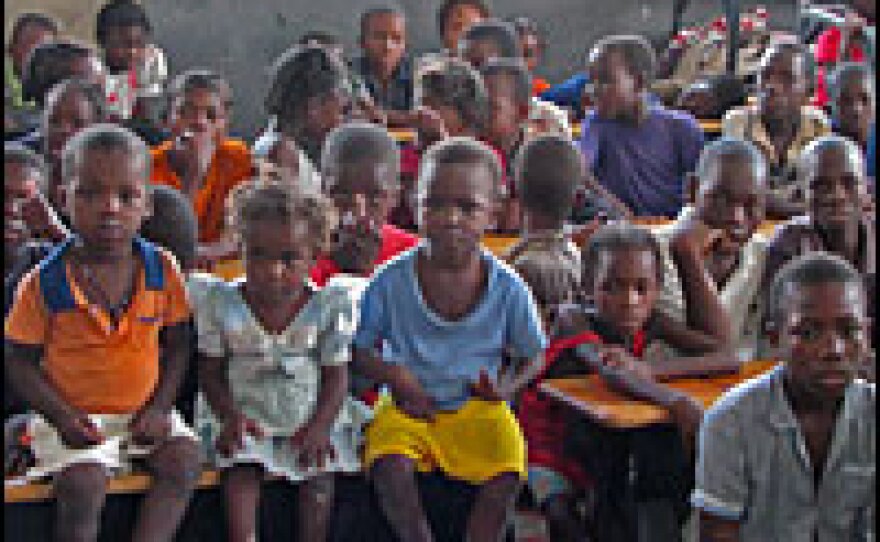 More than 100 children wait for a snack at a school that was turned into a shelter.