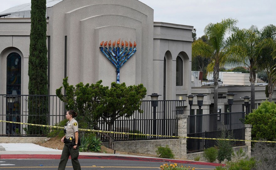 A San Diego county sheriff's deputy stands in front of the Chabad of Poway synagogue, Sunday, April 28, 2019.