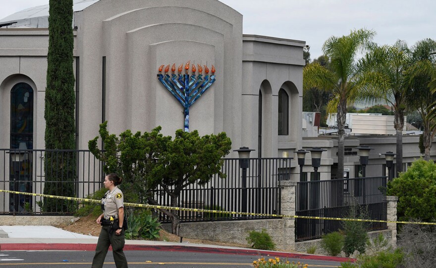 A San Diego county sheriff's deputy stands in front of the Chabad of Poway synagogue, Sunday, April 28, 2019. 