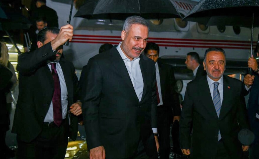 In this photo released by the Pakistan Ministry of Foreign Affairs, Turkish Foreign Minister Hakan Fidan, center, walks toward his car upon arrival to attend a meeting in Islamabad, Pakistan, Saturday, March 28, 2026.
