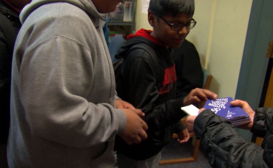 A Logan Elementary School student picks up an anti-bullying pamphlet, Feb. 2, 2017.