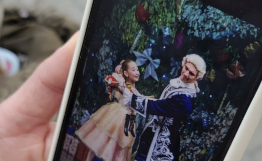 Kateryna Kltsova shows a picture on her phone of her older daughter Maria in a lavish production last Christmas of <em>The Nutcracker.</em>