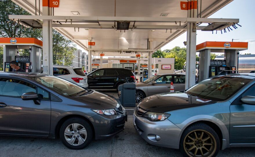Cars sit at gas pumps at a Gulf gas station in Lynnfield, Mass., on July 19. California's action to ban sales of new gas-powered vehicles could prove seminal in the country's transition to zero-emission cars.
