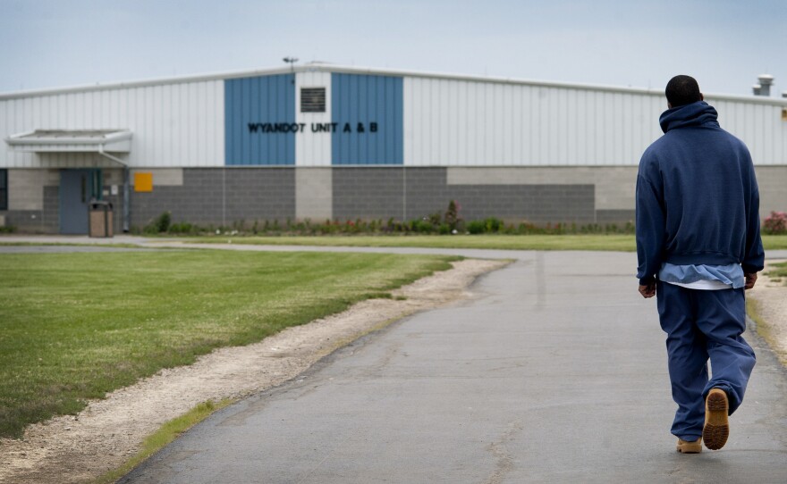 An inmate walks through the yard at the North Central Correctional Institution in Marion, Ohio, which recently switched to private management.