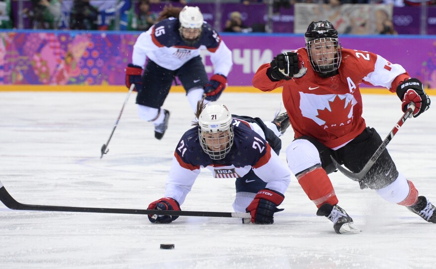 Canada's Hayley Wickenheiser (right) vies with America's Hilary Knight during overtime of the women's hockey gold medal game between Canada and the U.S. at the Bolshoy Ice Dome.