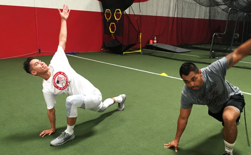 Shu stretches with trainer Eliseo Cabildo in Corona, Calif. Shu, 25, started playing badminton as an 8-years-old.