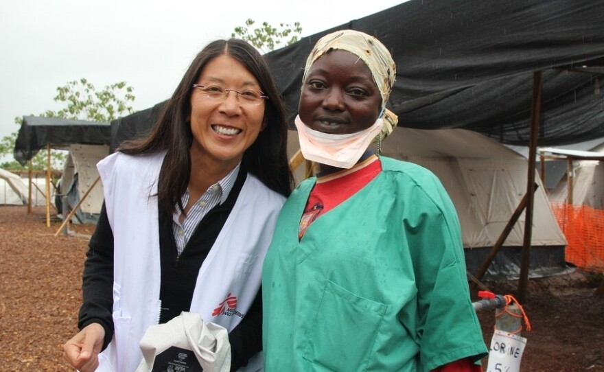 Dr. Joanne Liu (left), international president of Doctors Without Borders poses with a member of the MSF medical team at the organization's Ebola treatment center in Kailahun, Sierra Leone.