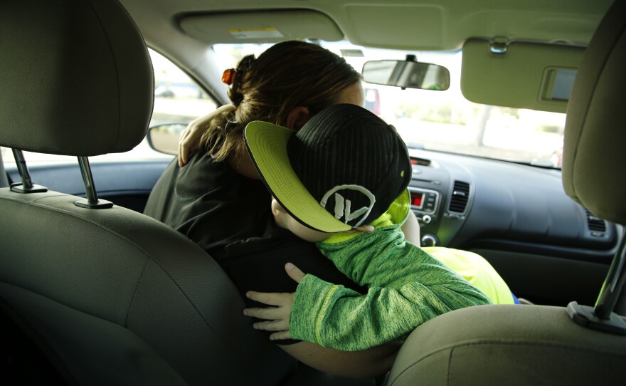Ayden and his mom, Lynn, hug after visiting the McDonald's drive-through in Port St. Lucie, Fla.