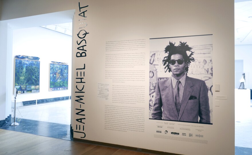 The entrance to an exhibit by artist Jean-Michel Basquiat is seen at the Orlando Museum of Art on June 1, 2022, in Orlando, Fla. A former Los Angeles auctioneer has pleaded guilty in a cross-country art fraud scheme where he created fake artwork and falsely attributed the paintings to artist Jean-Michel Basquiat.