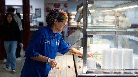 Great Valley School District culinary coordinator Jenifer Halin cleans up the salad bar in the cafeteria at Great Valley High School in Malvern, Pennsylvania.