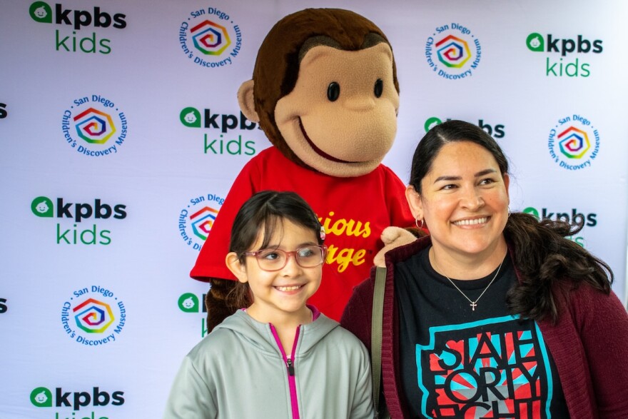 Children pose with Curious George in this undated photo at the San Diego Children's Discovery Museum.